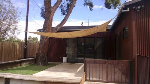 Backyard patio with a shade sail