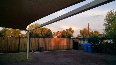 Sunset over a backyard fence