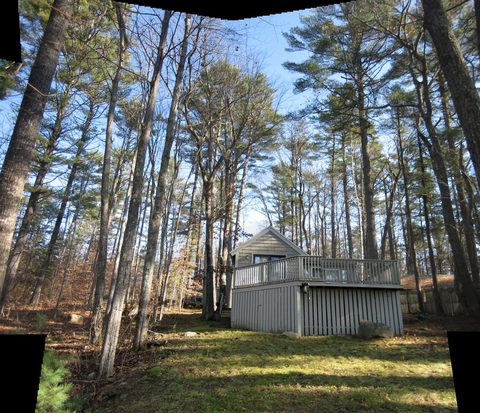 Wooded path leading to a small outbuilding