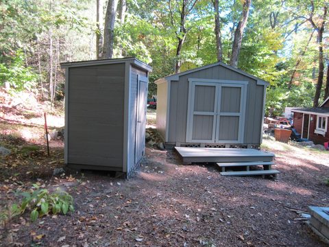 Two storage sheds beside a small deck
