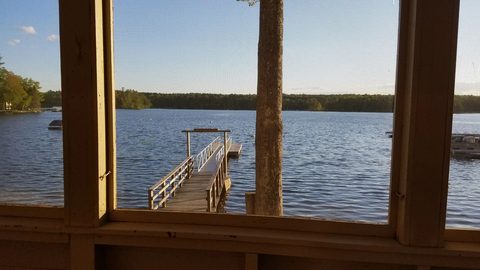 Lake and dock seen through porch windows