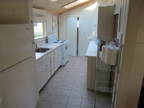 Kitchen with refrigerator and white cabinets