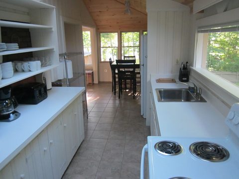 Kitchenette with open shelving and a small table